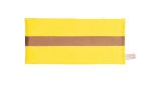 Saffron silk eye pillow with honey-coloured band on a white background