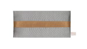 Silver silk eye pillow with honey-coloured band on a white background