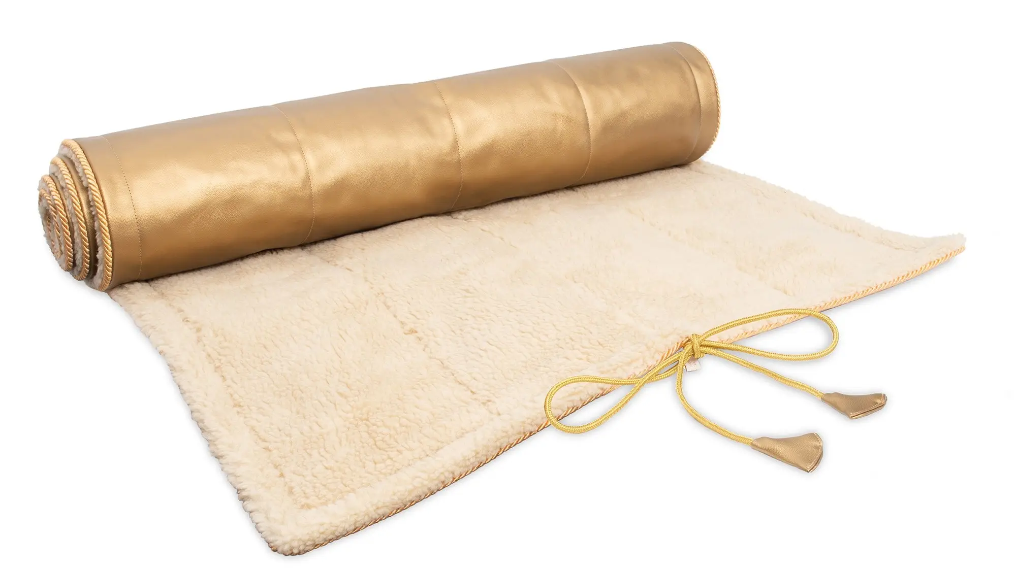 A rolled gold-colored mat partially unrolled to reveal a cream fleece surface with attached gold ties.