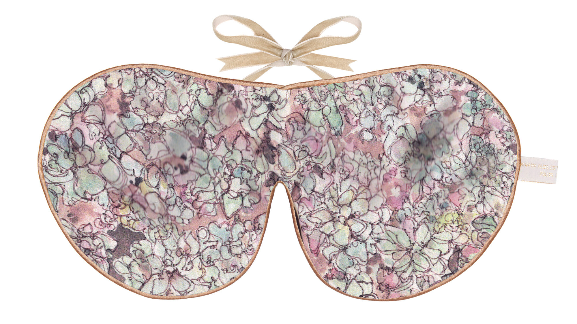 A silk sleep mask featuring a pastel succulent-inspired pattern with soft beige ribbon ties and gold edging.