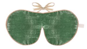 A jade green silk velvet sleep mask with gold edging and beige ribbon ties.”