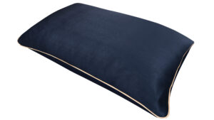 Navy silk pillowcase with honey-coloured piping on a white background