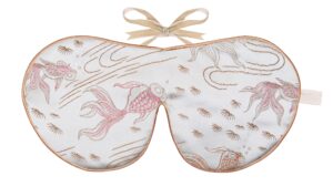 A silver silk sleep mask embroidered with flowing goldfish and water motifs in peach, rose‑gold, and gold threads, finished with gold edging and beige ribbon ties
