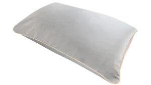 Silver silk pillowcase with honey-coloured piping on a white background