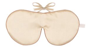Cream silk sleep mask with a soft bow tie fastening.