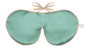 Jade silk sleep mask with honey‑coloured piping and silk ribbon tie, shown flat on a white background.