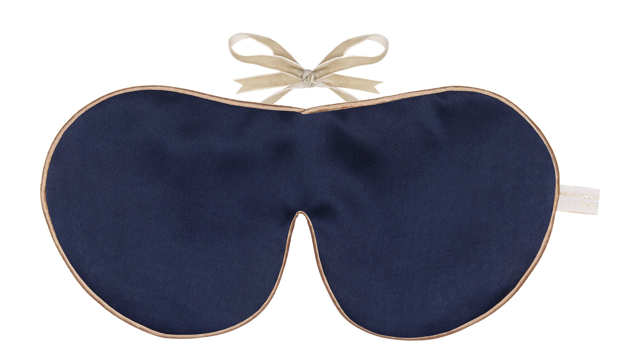 A navy blue silk sleep mask with gold edging and beige ribbon ties