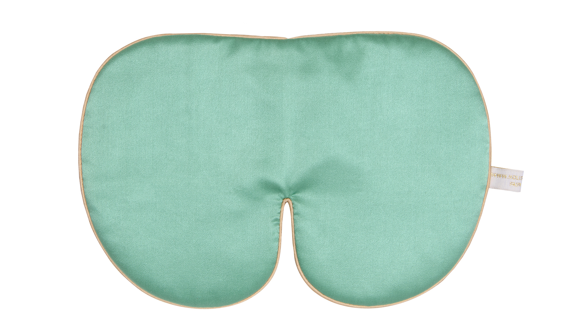 An oversized jade‑green silk sleep mask with smooth fabric, gold edging, and a soft curved shape.