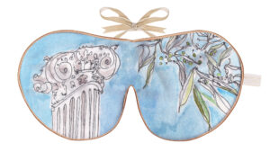 Silk sleep mask with a blue watercolour background featuring an illustrated classical column and leafy branches.