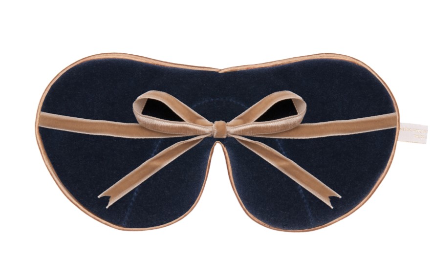 reverse side of an eye mask with soft cotton velvet lining and contrasting colour ribbon ties displayed against a neutral background.