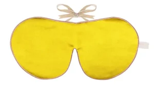 Sundrop yellow silk sleep mask with honey‑coloured piping and silk ribbon tie, shown flat on a white background.